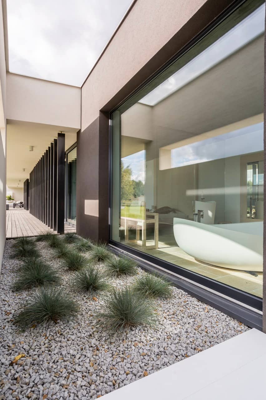 Large bathroom window looking onto a gravel garden