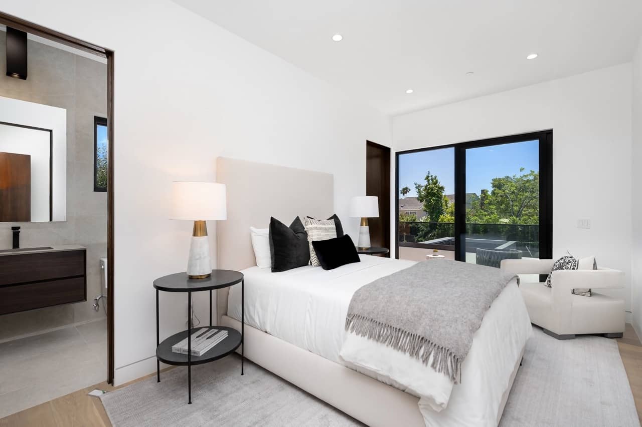 Bedroom with a large window and an ensuite bathroom